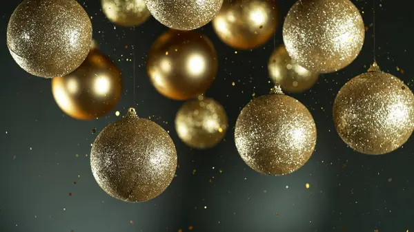 Christmas Holiday Balls with Falling Glittering Particles. Beautiful Decorative Background with Christmas Holiday Theme.