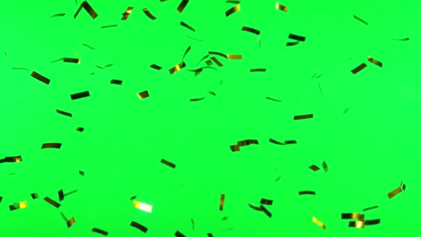 Super Slow Motion Flying Golden Confetti Isolated Green Background Filmed — Stock Video