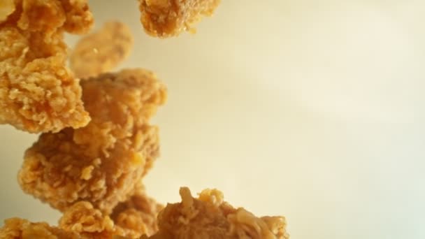 Super Slow Motion Flying Fried Chicken Piecers Golden Background Kamera — Stok Video