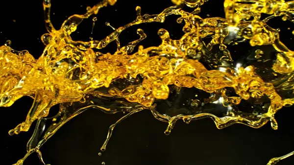 Sunflower Oil Splashing Golden Background Studio Shot Abstract Shape Stock Photo