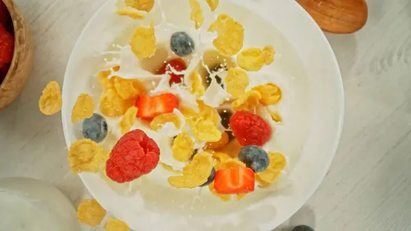 Freeze Motion Falling Cereals Bowl Milk Overhead Table Top Shot — стокове фото
