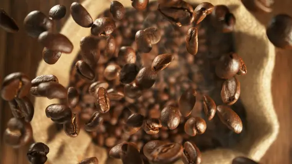 Freeze Motion Flying Coffee Beans Jute Sack Overhead Shot Stock Photo
