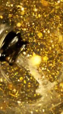 Şampanyayı bardağa doldurmanın süper yavaş hareketi. Glass Bottom 'dan benzersiz bir bakış açısı. High Speed Cinema Camera 'da çekildi, 1000 fps. Dikey Görünüm Oranı.