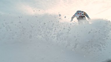 Free Ride Snowboarder Running Down the Hill. Freeze Motion. Powder Snow Exploding. Cloudy Sky. clipart