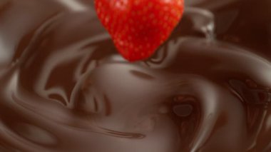 Super Slow Motion of Falling Strawberry into Melted Chocolate. Filmed on High Speed Cinema Camera, 1000fps.
