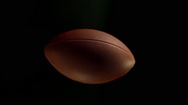 Hareket Eden Amerikan Futbol Topunun Süper Yavaş Hareketi. Kara Arkaplan 'da izole edilmiş. Üst Manzara. Yüksek Hız Sinema Kamerası, 1000fps. 