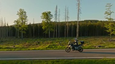 Dağ manzarasında motosiklet sürücüsü. Sunset Light ile Güzel Yaşam Tarzı Panoramik Manzarası. Motosiklette yaşam tarzı turu.