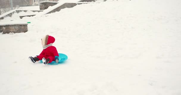 冬の雪の中で楽しんでいる母と幼い幼児の息子 冬休み 楽しい休暇 スリーライディングコンセプト — ストック動画