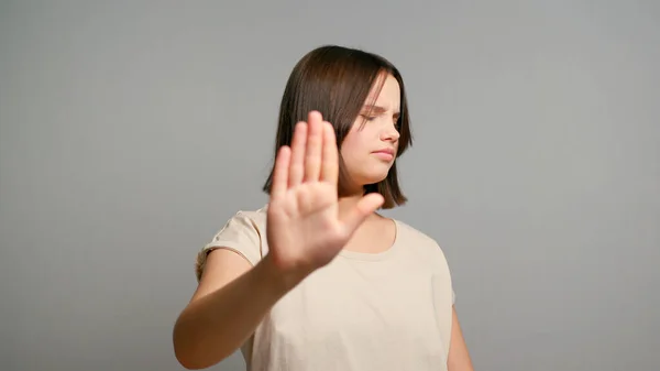 No. Courageous latin teenager girl extend hand in stop gesture oppose against domestic sexual violence abuse racial gender discrimination. Gen z rebel against violation of women rights. Copy space.