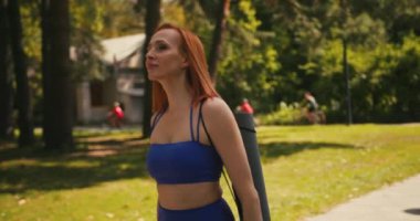 Yürüyen Kendine Güvenen Orta Çağ Spor Giyimli Kadın Yoga minderli Portresi. Güzel bir kadın şehir ortamında eğitime gider..