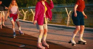 Gündelik giysiler içinde çok kültürlü kadınlar paten kayıyor. Güneşin doğuşunda eğlenirken Güzel Arkadaşların Dönüşü ve Dönüşü 'nü Uydur. Fitness Gençlik Kültür Çeşitliliği.