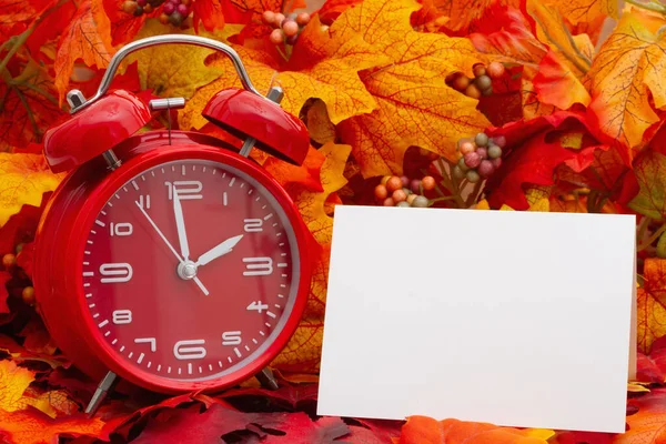 目覚まし時計付きの空白のグリーティングカードとあなたの時間の変更や秋の時間のメッセージの葉 — ストック写真