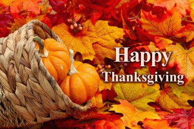 Happy Thanksgiving message with a cornucopia and pumpkins and fall leaves clipart