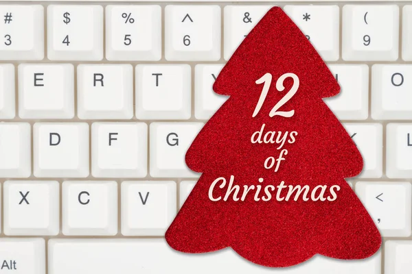 あなたの休日のオンラインショッピングメッセージのためのキーボードの赤いクリスマスツリーギフトタグのクリスマスメッセージの12日間 — ストック写真