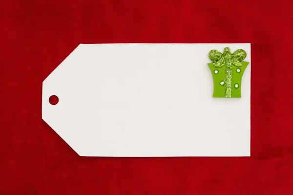 Blank Weiße Geschenkanhänger Mit Einem Weihnachtsgeschenk Auf Rotem Plüsch Für — Stockfoto