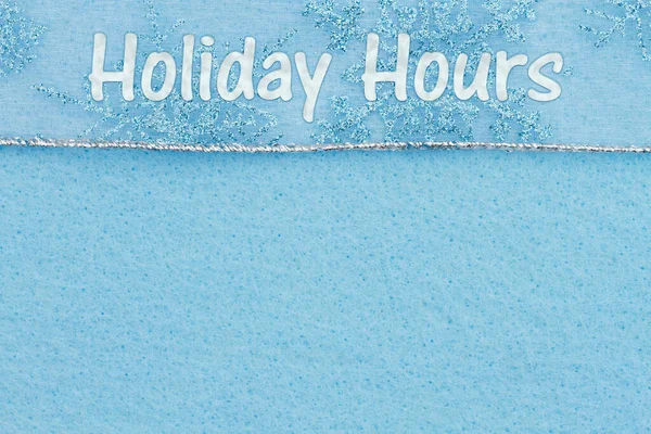 Holiday Hours message with snowflakes on blue felt with space for your opening hours