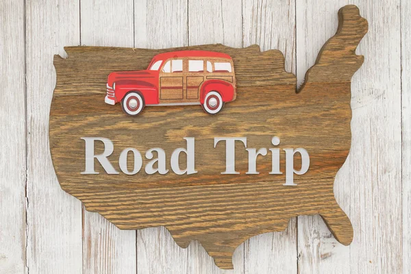 Road Trip USA with old retro car on weathered wood USA map on whitewash