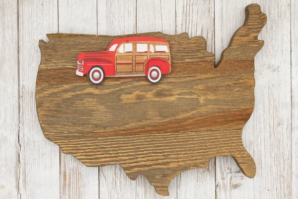 Road Trip USA with old retro car on weathered wood USA map on whitewash
