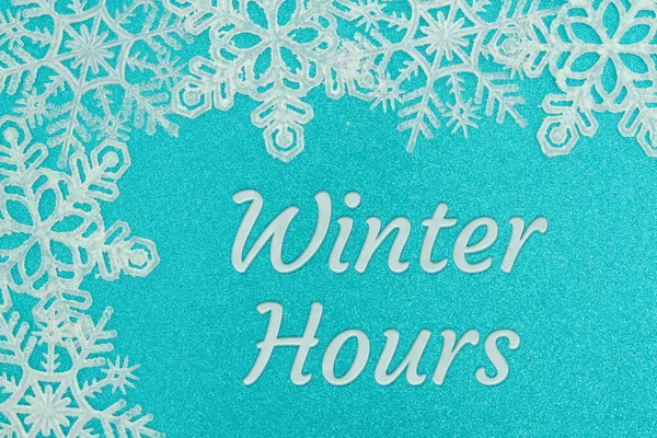 Winter Hours blue sign with white snowflakes for your winter or seasonal opening hours message