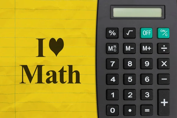 I love math message on bright yellow ruled line notebook crumpled paper with a calculator
