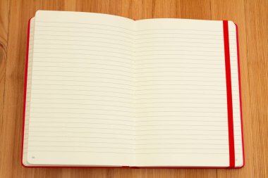 Lined journal on wood desk for your daily writing message