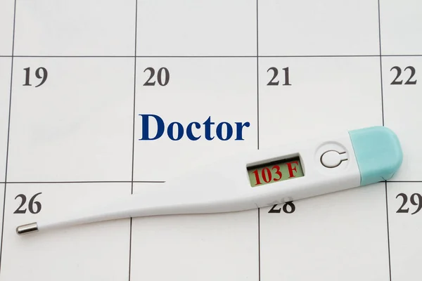 Schedule your doctors appointment with a digital thermometer with a display on a calendar