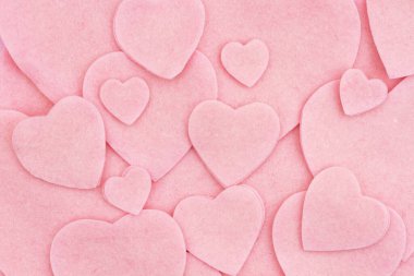 Lots of pink felt hearts love background for your romance or dating message