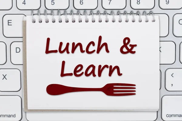 Lunch and Learn message with a fork on a notepad on a computer keyboard