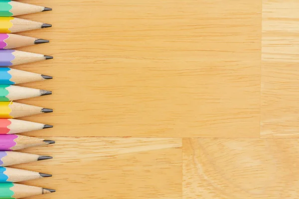 教育や学校のメッセージのための木製の机の上にパステルカラーの鉛筆の背景 — ストック写真