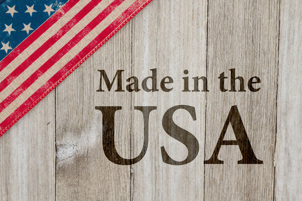 Made in America message, USA patriotic old flag on a weathered wood background with text Made in the USA