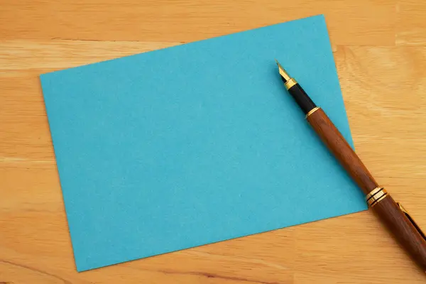 Blank Blue Greeting Card Pen Wood Desk Royalty Free Stock Photos