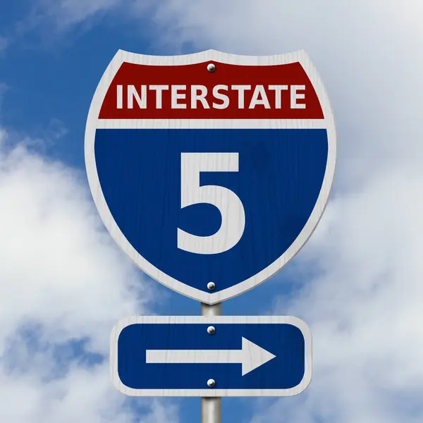 stock image USA Interstate 5 highway sign, Red, white and blue interstate highway road sign with number 5 with sky background