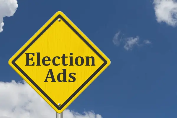 stock image  Yellow warning Election Ads road sign with sky