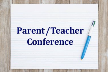 Parent Teacher conference with retro lined school paper with pen on weathered wood desk clipart