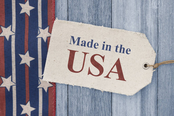 Made in the USA price tag with retro USA red, white and blue stars on weathered wood 