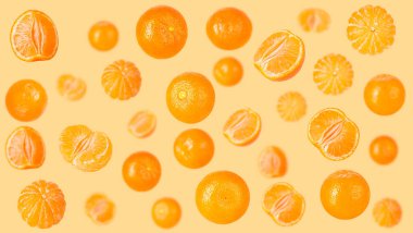 Creative levitation pattern with whole and pieces peeled tangerines. Selective focus. Isolated fruit. Packaging concept. Clip art image for package design.
