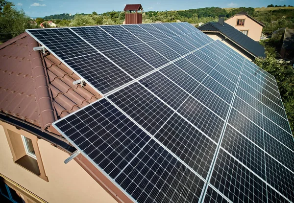 stock image Aerial top view of new modern house cottage with solar photovoltaic panel system on house roof