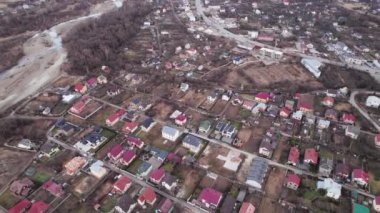 Aerial drone video of residential district with houses, buildings, streets and homes with photovoltaic solar panels. Modern houses with renewable sources of energy in suburban neighborhood.