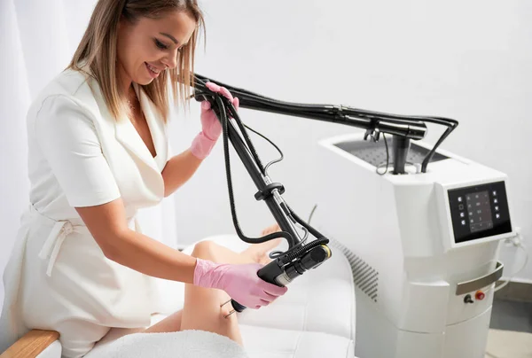 医生在美容院用二氧化碳激光治疗病人腿上的皮肤 美容师与现代设备一起致力于激光皮肤更新的五金美容术 — 图库照片