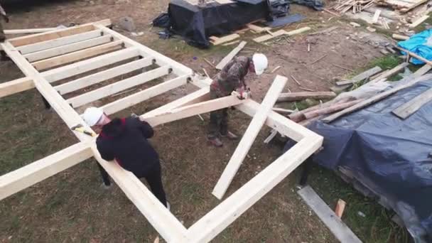 Men Workers Building Wooden Frame House Pile Foundation Carpenters Installing — Stock Video
