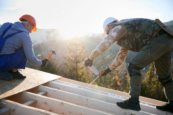 Male Builder Doing Thermal Insulation Roof Wooden Frame House Morning — Stock Photo, Image