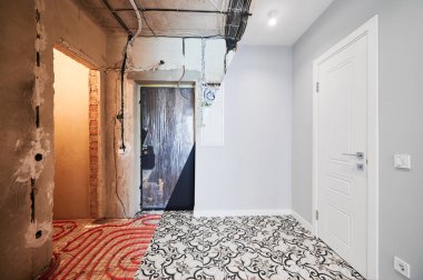 Comparison of old flat with underfloor heating pipes and new renovated apartment with modern interior design. Hallway with heated floor before and after renovation.