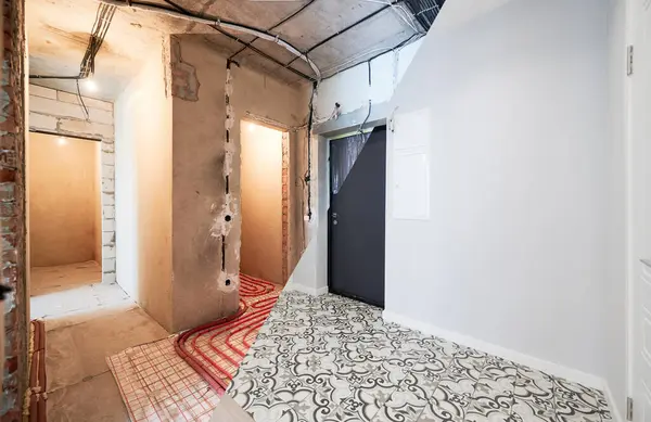 Old apartment with brick walls and new renovated flat with doors and stylish design in white tones. Inferior of apartment before and after renovation.