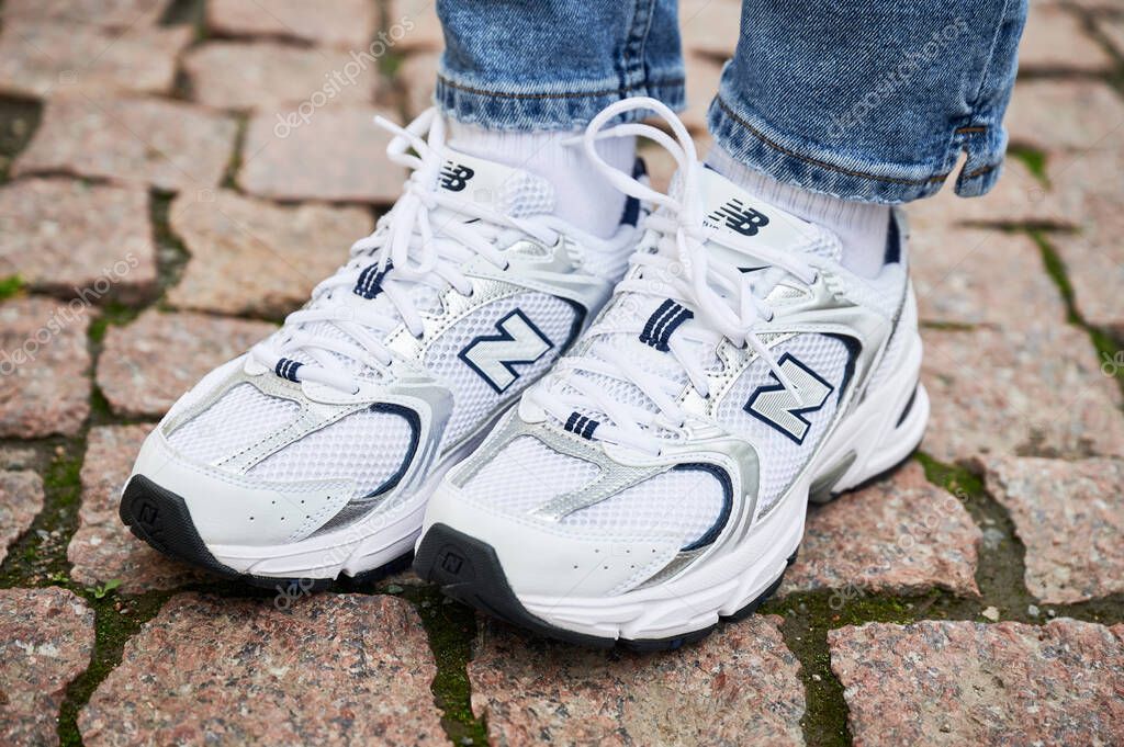 Lviv, Ukraine - May 9, 2023: close up photo of girl in jeans wearing New Balance 530. Cropped photo of woman wearing casual outfit with comfy shoes.