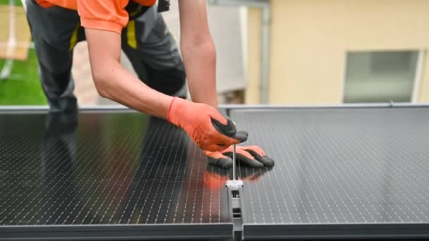 工人在房顶上建造光伏太阳能电池板系统 在室外用六角钥匙安装太阳能组件的手套中的人类工程师的近视 替代能源生产概念 — 图库视频影像