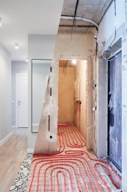 Old apartment with brick walls and new renovated flat with doors, mirror and stylish design in white tones. Inferior of apartment before and after renovation.
