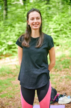 Ormanda yoga yapan bir kadın. Sakin, doğal bir ortamda..