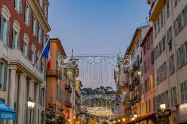 Nice, France - December 20, 2021 Colorful Illuminated Christmas Holiday Decorations Restaurants Stores Street Building Facades Cityscape Nice Cote d'Azur France