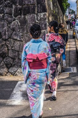 Kyoto, Japan - November 13, 2023 Japanese Women with Colorful Pink Blue Traditional Japanese Kimonos Walking to Kiyomizu Buddhist Temple Kyoto Japan. Many Japanese women wear traditional Japanese kimonos to temples. clipart