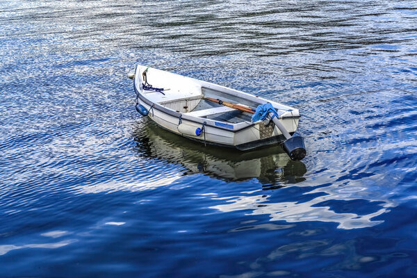 Colorful White Rowboat Blue Water Reflection Abstract Background Patterns Harbor  Dartmouth Devon England. 